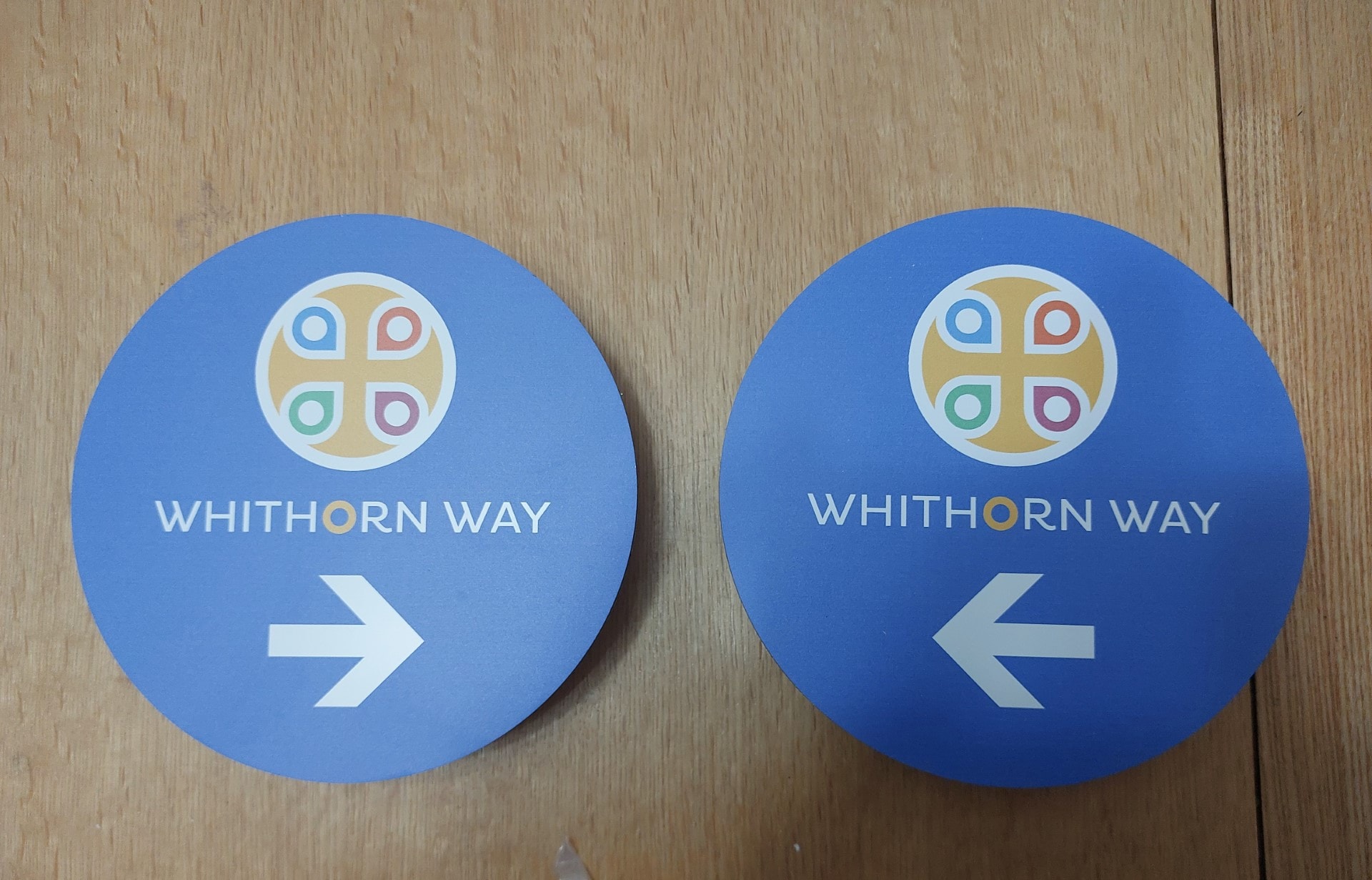 Blue circular Whithorn Way roundel signs with directional arrows